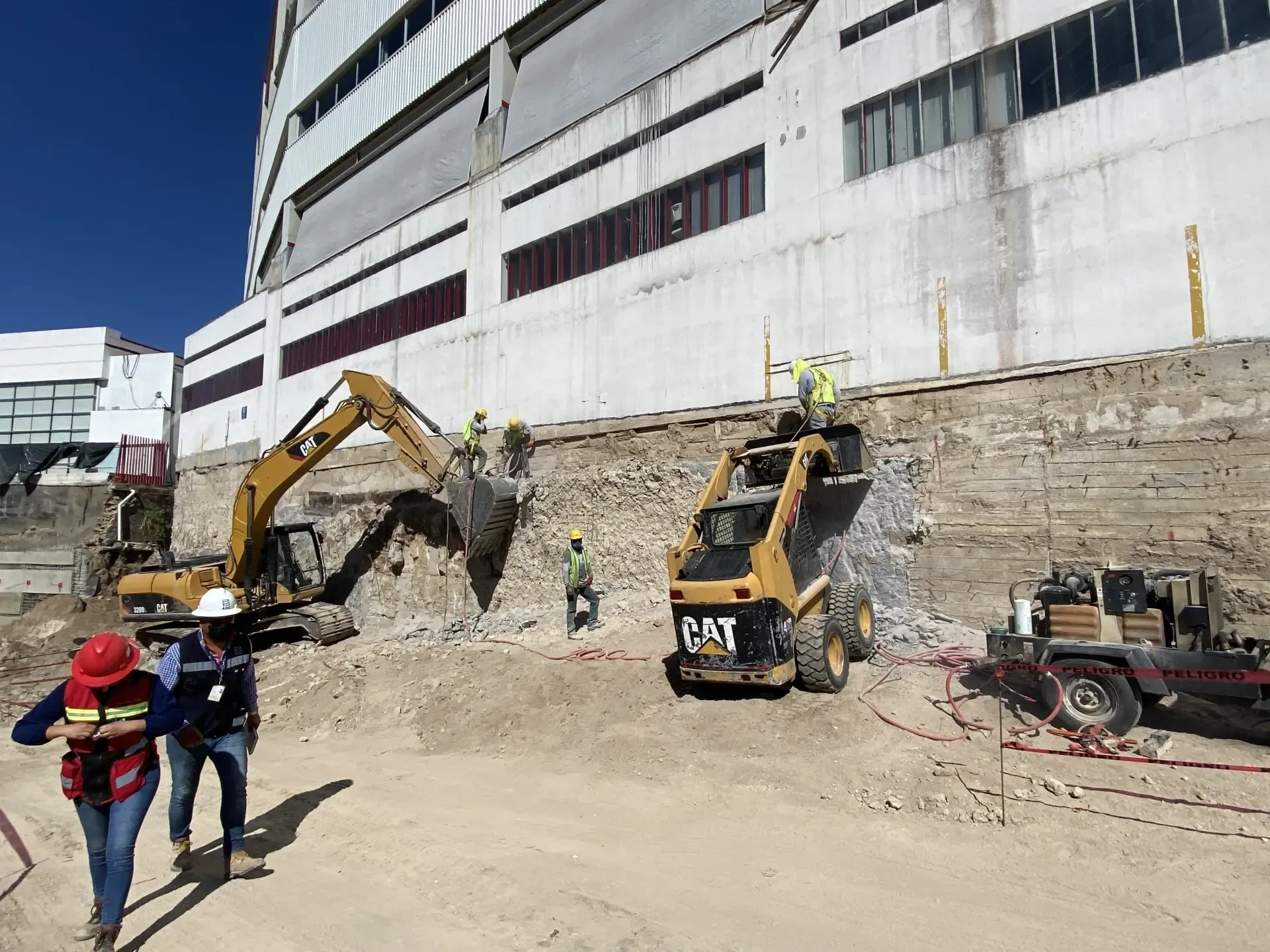 Dos excavadoras CAT y personal de obra civil realizando excavaciones en un terreno en Zapopan.
